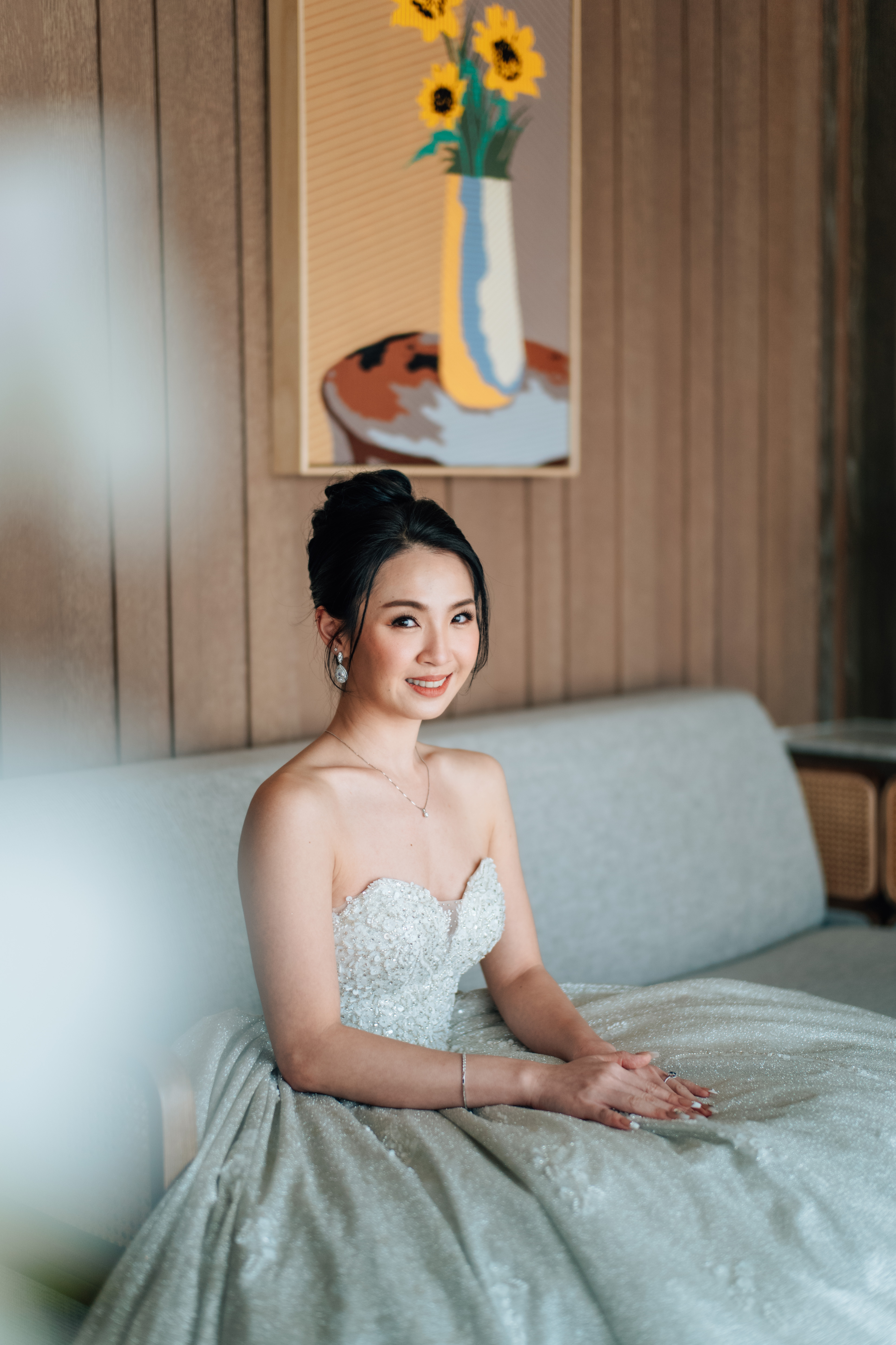 Bride receiving final touch-ups, radiant soft-glam look
