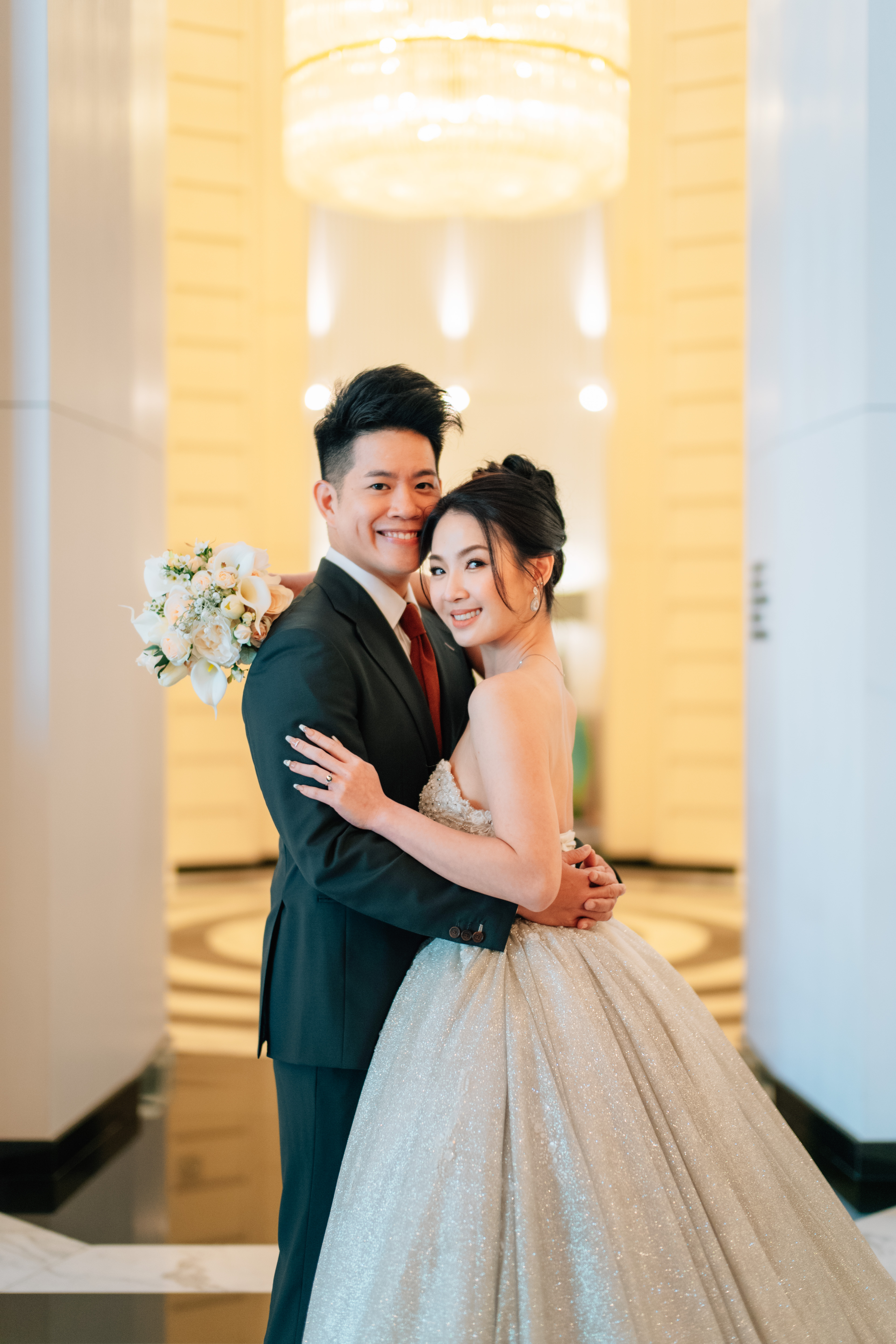 Bride in lace gown facing forward with natural glow