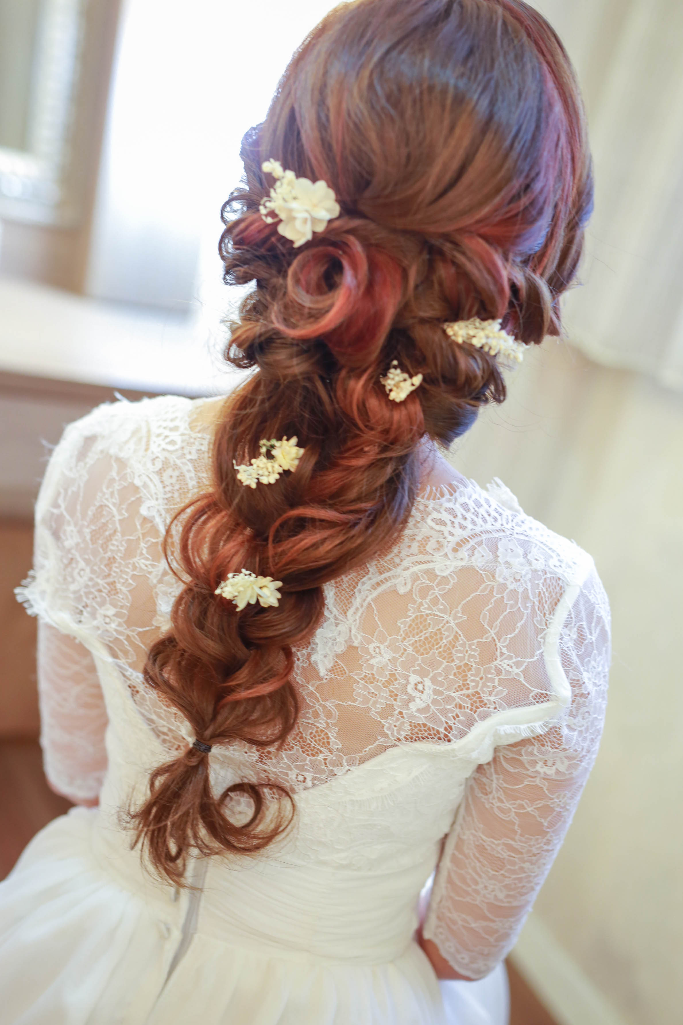 Editorial bridal portrait highlighting sleek bun and dewy skin